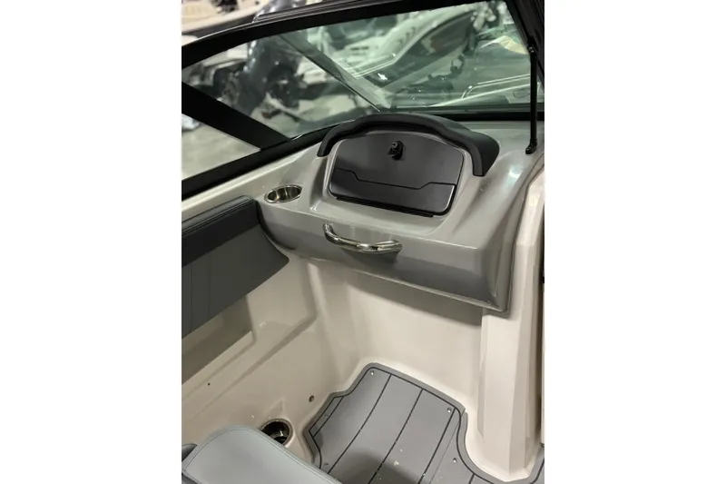 Slide: The Image of 2026 Chaparral 23 SSi boat interior with sleek dashboard and modern design. - 24