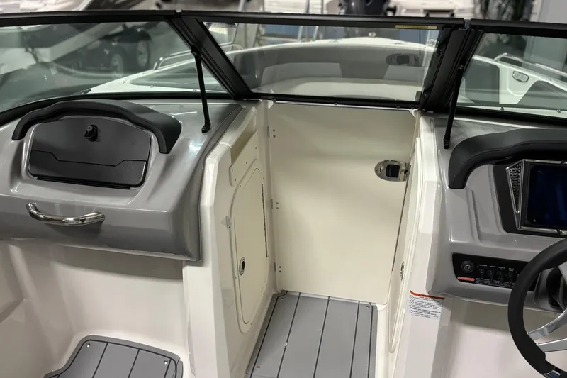 Slide: The Image of 2026 Chaparral 23 SSi boat interior with sleek dashboard and modern controls. - 25
