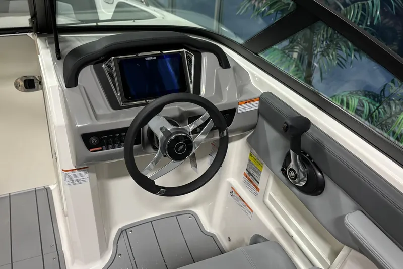 Slide: The Image of 2026 Chaparral 23 SSi boat dashboard with steering wheel and control panel. - 26