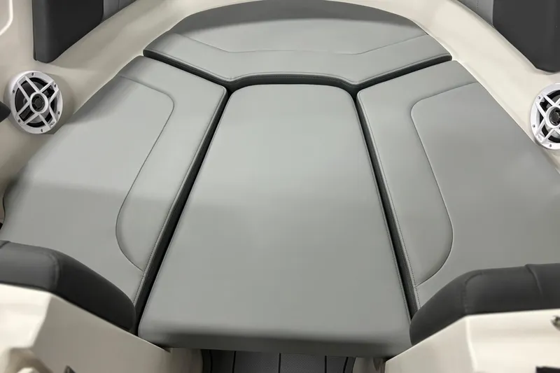 Slide: The Image of Interior seating of 2026 Chaparral 23 SSi boat with gray upholstery and speakers. - 27