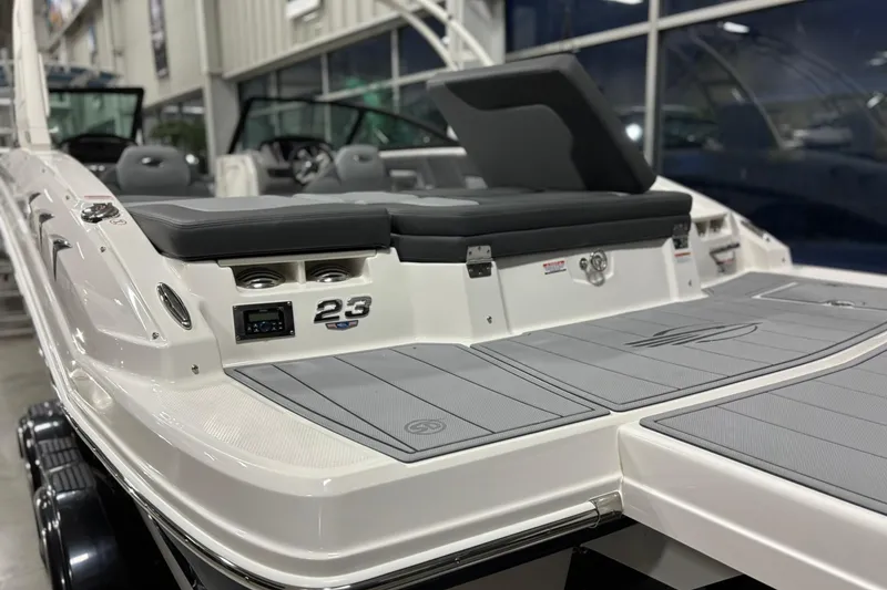 Slide: The Image of 2026 Chaparral 23 SSi boat, rear view, showcasing sleek design and seating area. - 8