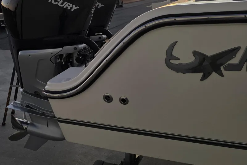 Slide: The Image of 2020 Mako 284 Center Console boat with Mercury outboard engines, rear view. - 11