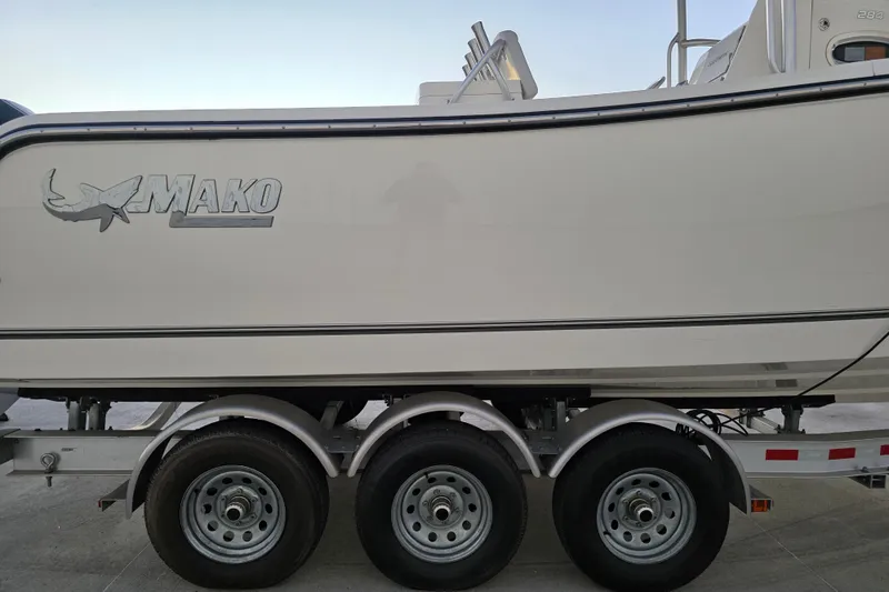 Slide: The Image of 2020 Mako 284 Center Console boat on trailer, side view with logo visible. - 13