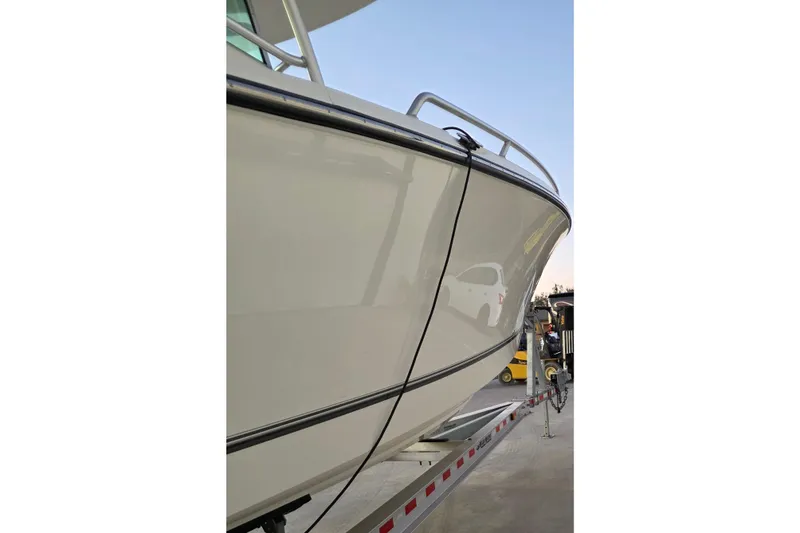 Slide: The Image of 2020 Mako 284 Center Console boat on trailer, side view. - 14