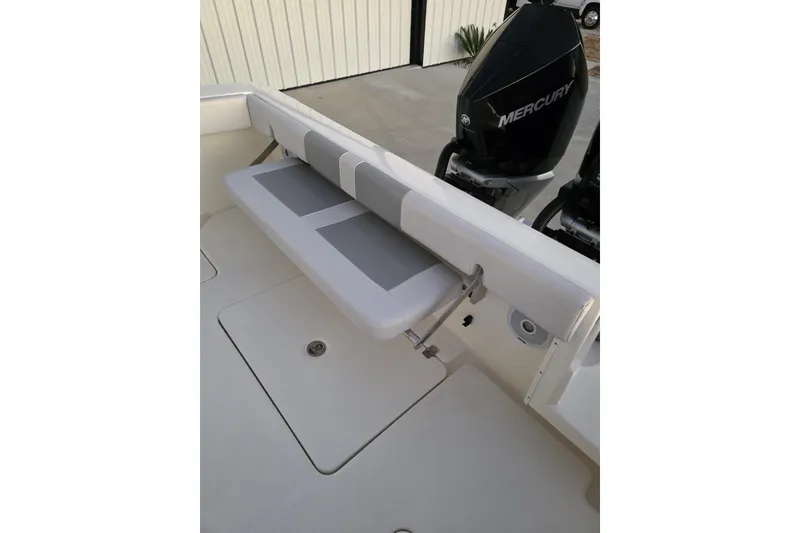 Slide: The Image of 2020 Mako 284 Center Console boat with foldable seat and Mercury engine. - 17
