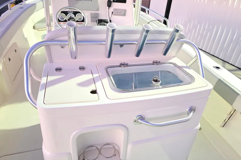 Slide: The Image of 2020 Mako 284 Center Console boat with rod holders and storage compartments. - 18