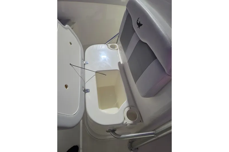 Slide: The Image of 2020 Mako 284 Center Console boat seat with storage compartment open. - 25