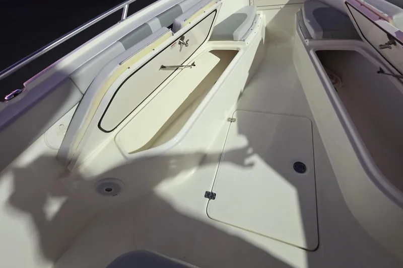 Slide: The Image of 2020 Mako 284 Center Console boat interior with open storage compartments. - 27