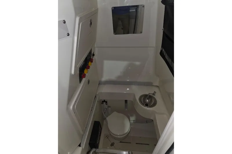 Slide: The Image of 2020 Mako 284 Center Console boat interior with toilet and sink. - 29
