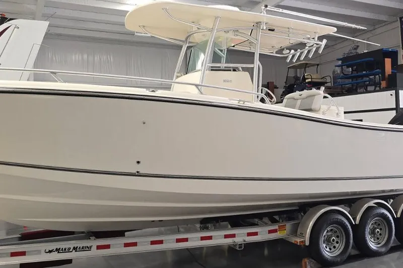 Slide: The Image of 2020 Mako 284 Center Console boat on trailer in indoor storage. - 3