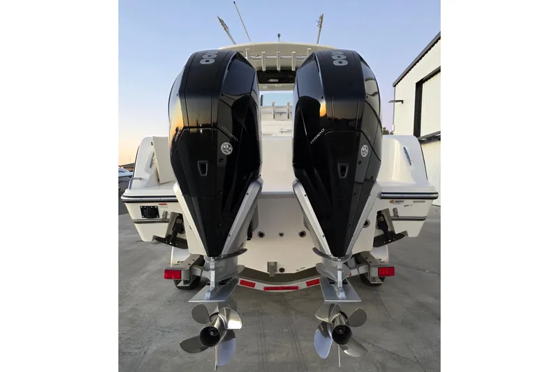 Slide: The Image of 2020 Mako 284 Center Console boat with dual outboard engines, rear view. - 7