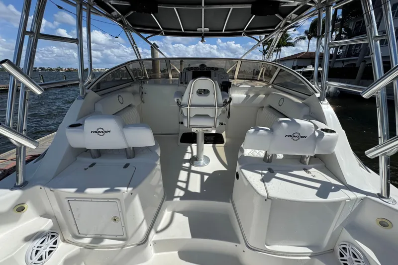 Slide: The Image of 2007 Fountain 33 Sportfish Cruiser interior with helm, seating, and ocean view. - 11