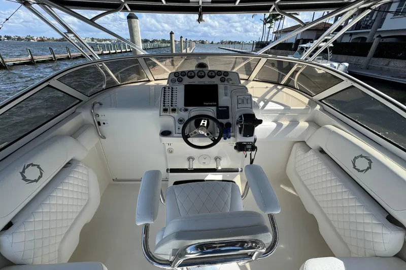 Slide: The Image of 2007 Fountain 33 Sportfish Cruiser helm with luxurious seating and advanced navigation controls. - 12