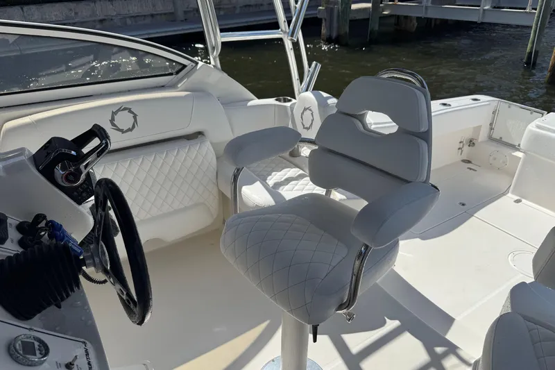 Slide: The Image of 2007 Fountain 33 Sportfish Cruiser interior with white seating and steering wheel. - 16