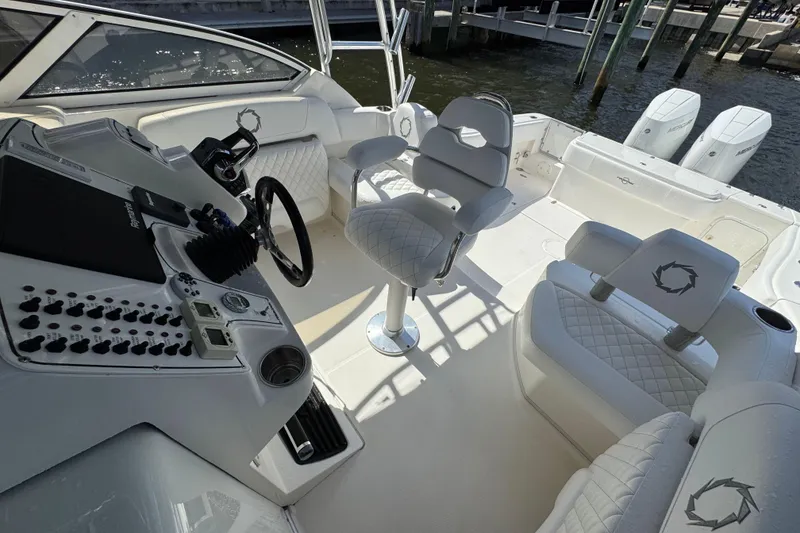 Slide: The Image of 2007 Fountain 33 Sportfish Cruiser interior with white seating and control panel. - 3