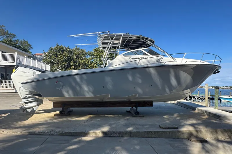 Slide: The Image of 2007 Fountain 33 Sportfish Cruiser on dock, side view, clear sky background. - 5