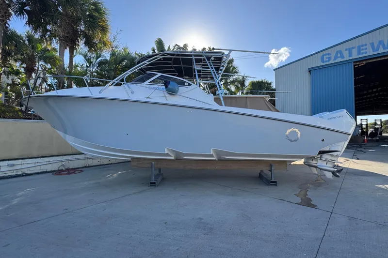 Slide: The Image of 2007 Fountain 33 Sportfish Cruiser on display at a marina with palm trees. - 6