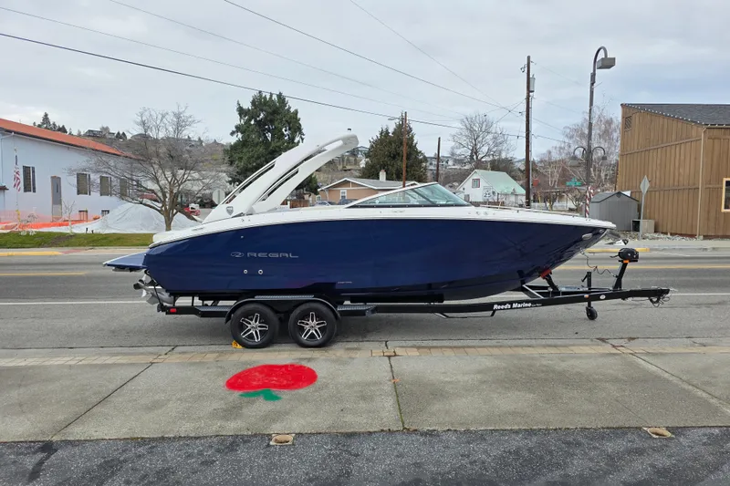 The Image of 2026 Regal LS6 boat on trailer, parked on street, overcast day. - 0