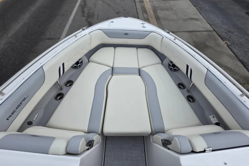 Slide: The Image of 2026 Regal LS6 boat interior with plush seating and cup holders. - 12