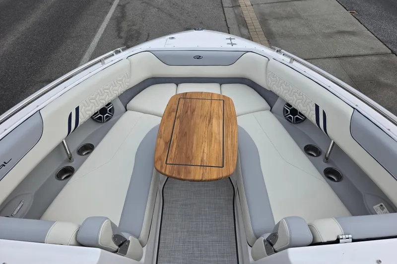 Slide: The Image of 2026 Regal LS6 boat interior with elegant seating and wooden table. - 13