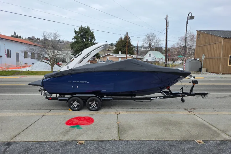 Slide: The Image of 2026 Regal LS6 boat on trailer, covered, parked on street. - 4