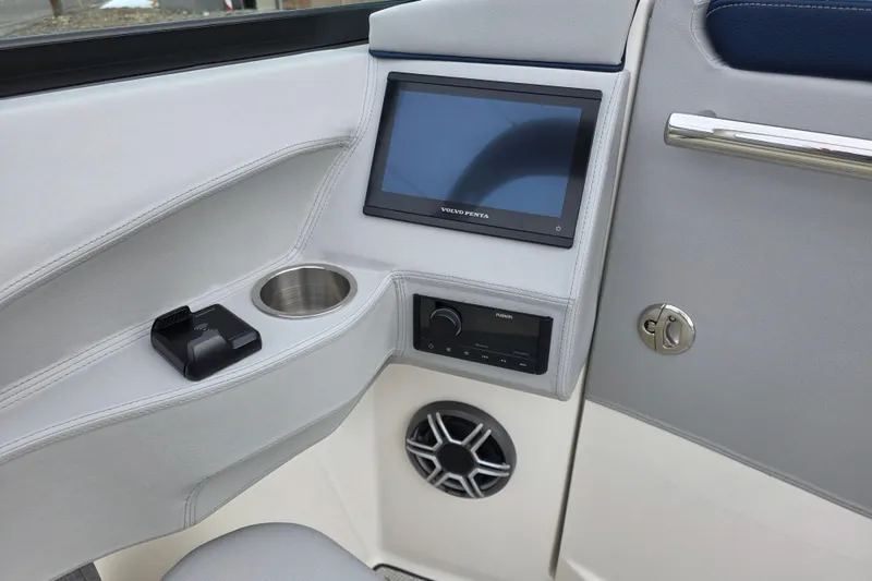 Slide: The Image of 2026 Regal LS6 boat interior with touchscreen, cup holder, and audio system. - 9