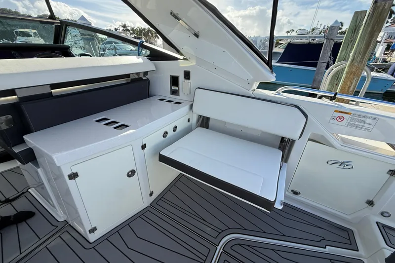 Slide: The Image of 2022 Monterey 385SS Super Sport boat interior with seating and storage compartments. - 11