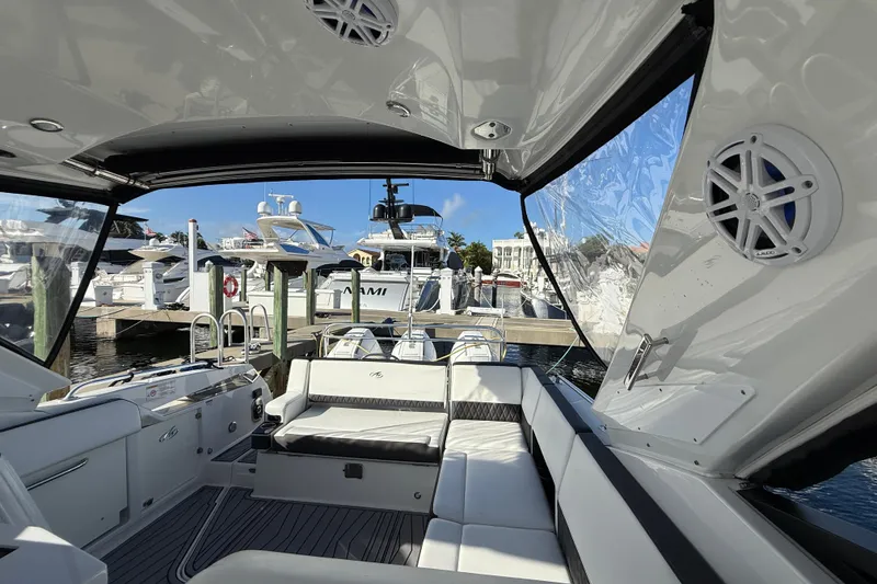 Slide: The Image of 2022 Monterey 385SS Super Sport boat interior at marina, showcasing luxury seating and design. - 12