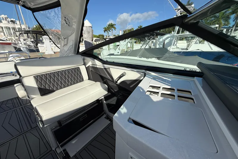 Slide: The Image of 2022 Monterey 385SS Super Sport boat interior with luxurious seating and modern dashboard. - 16