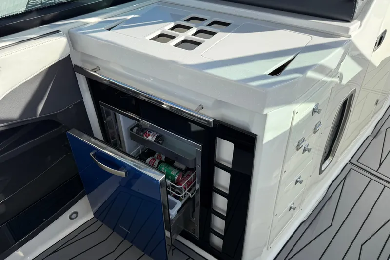 Slide: The Image of 2022 Monterey 385SS Super Sport boat with open mini fridge stocked with drinks. - 18
