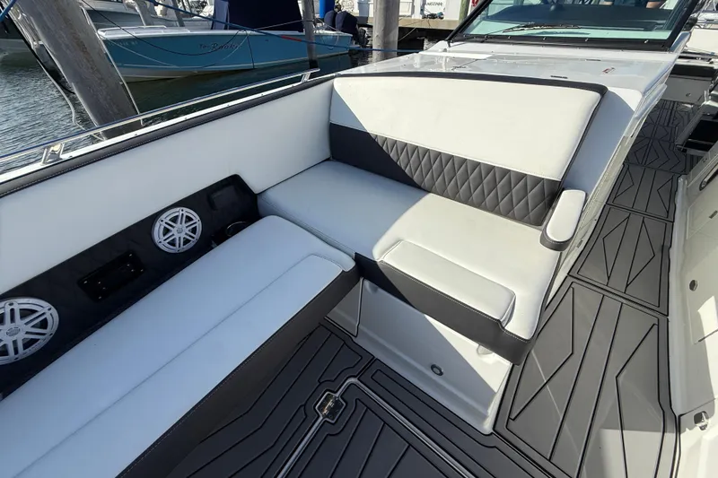 Slide: The Image of 2022 Monterey 385SS Super Sport boat interior with cushioned seating and marine speakers. - 22