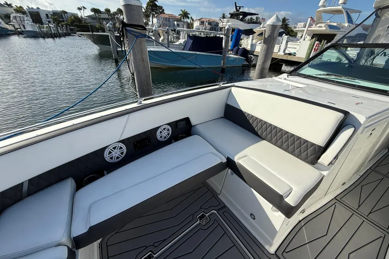 Slide: The Image of 2022 Monterey 385SS Super Sport boat interior with luxurious seating and waterfront view. - 24