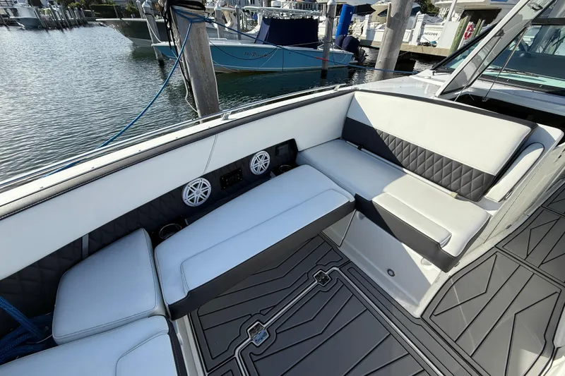 Slide: The Image of 2022 Monterey 385SS Super Sport boat interior with cushioned seating and speakers. - 27