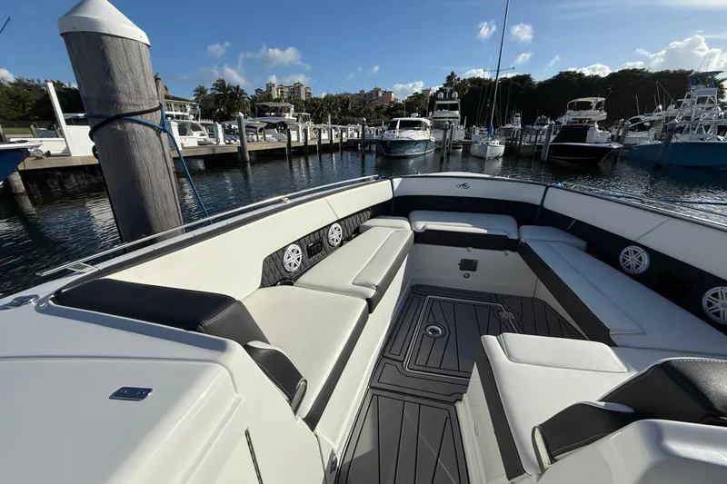 Slide: The Image of 2022 Monterey 385SS Super Sport boat interior at marina, featuring spacious seating and modern design. - 29