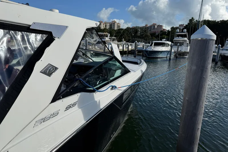Slide: The Image of 2022 Monterey 385SS Super Sport boat docked at marina, clear sky background. - 3