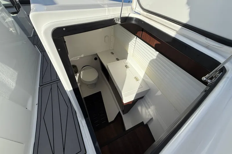 Slide: The Image of 2022 Monterey 385SS Super Sport boat interior with compact bathroom and storage. - 30