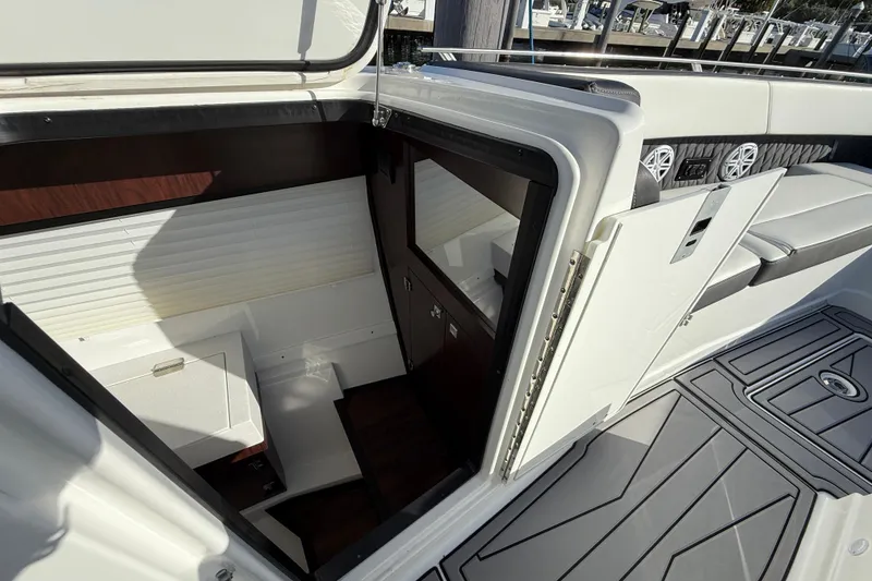 Slide: The Image of 2022 Monterey 385SS Super Sport boat interior with seating and storage area. - 31
