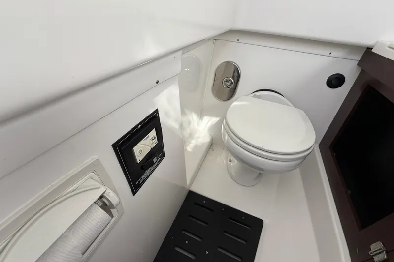 Slide: The Image of 2022 Monterey 385SS Super Sport boat bathroom interior with toilet and control panel. - 33