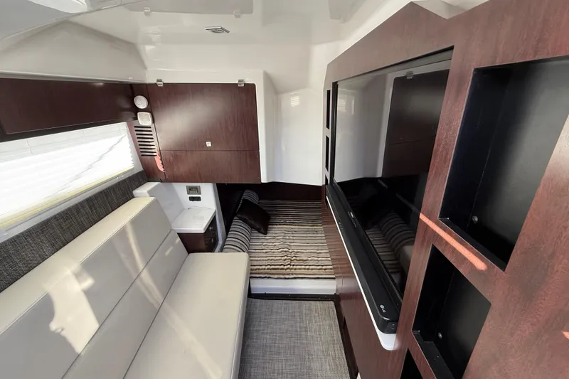 Slide: The Image of Interior of 2022 Monterey 385SS Super Sport boat with modern seating and wood finishes. - 39