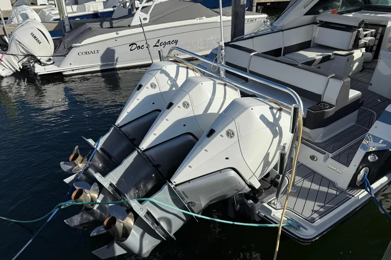 Slide: The Image of 2022 Monterey 385SS Super Sport boat with triple outboard engines docked at marina. - 4