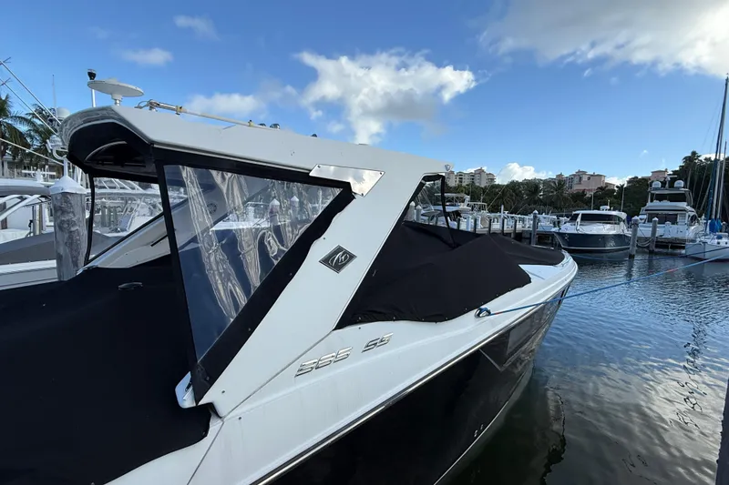 Slide: The Image of 2022 Monterey 385SS Super Sport boat docked at marina under blue sky. - 59