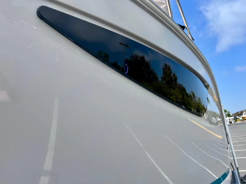 Slide: The Image of 2019 Regal 26 XO boat hull with sleek design and reflective surface. - 12