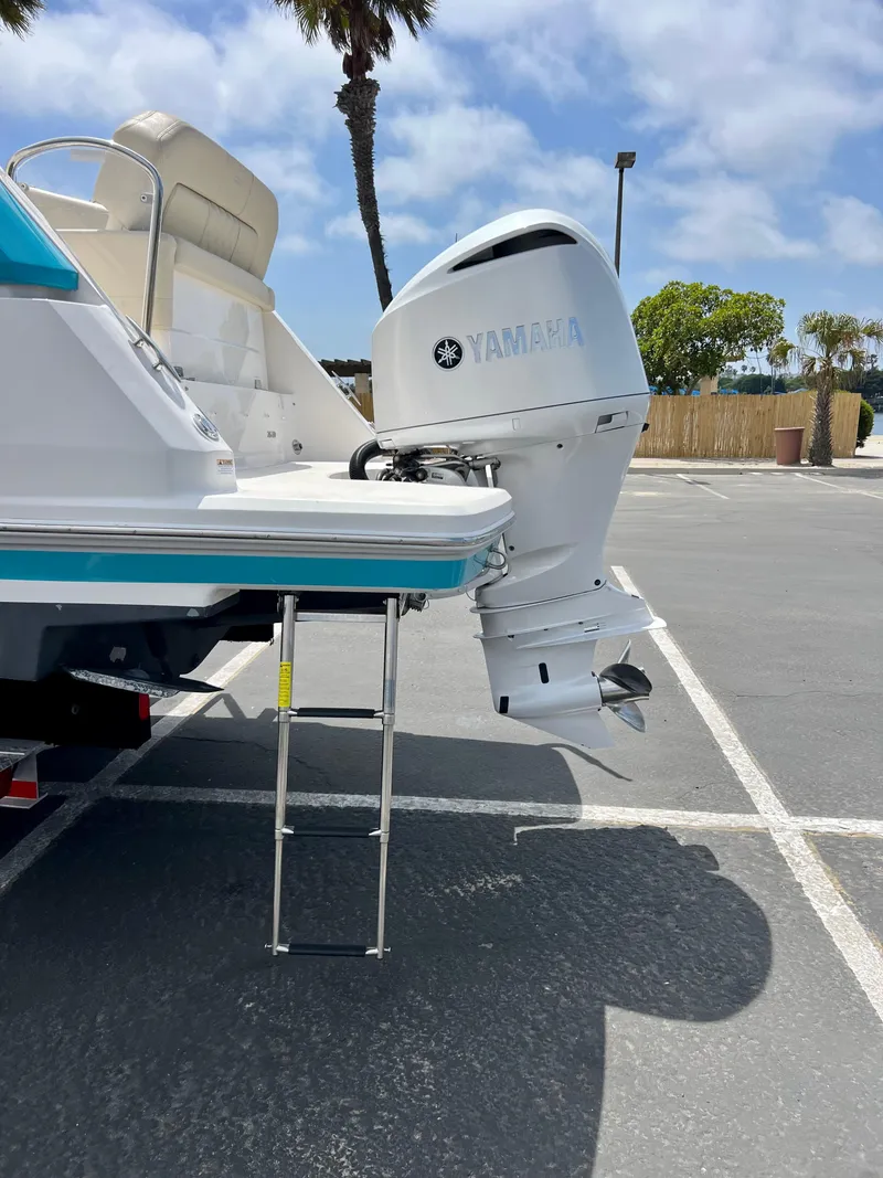 Slide: The Image of 2019 Regal 26 XO boat with Yamaha outboard motor in parking lot. - 15