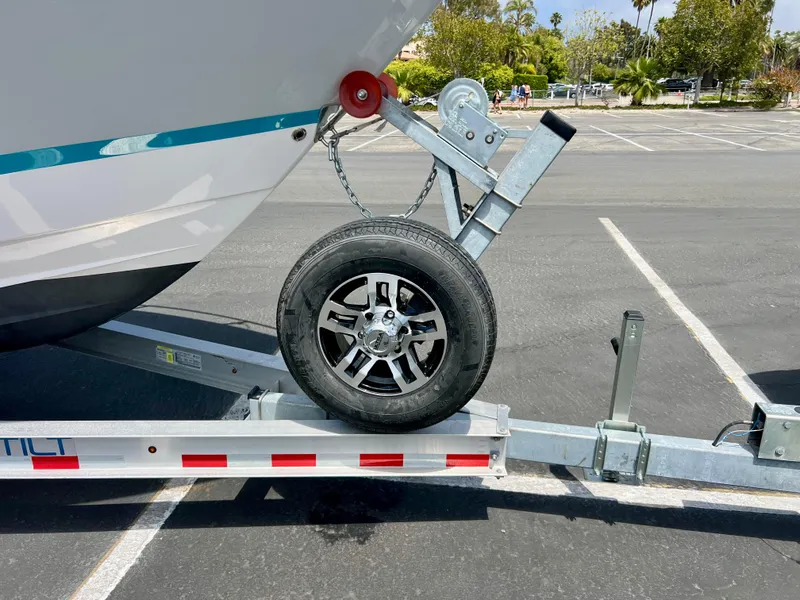 Slide: The Image of 2019 Regal 26 XO boat on trailer in parking lot. - 21