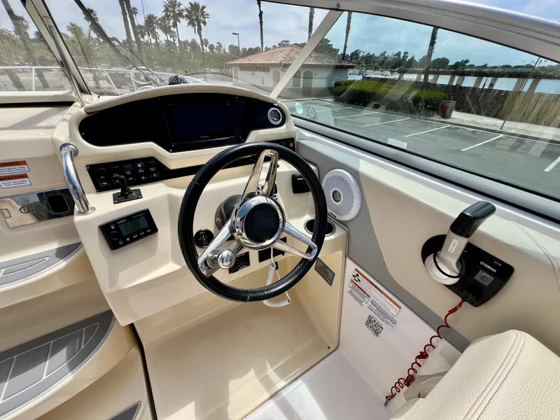 Slide: The Image of 2019 Regal 26 XO boat helm with steering wheel and control panel. - 39