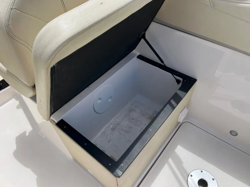Slide: The Image of Open storage compartment in 2019 Regal 26 XO boat seat. - 42