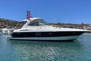 Slide: The Image of 2005 Cruisers 420 yacht on clear water under blue sky. - 2