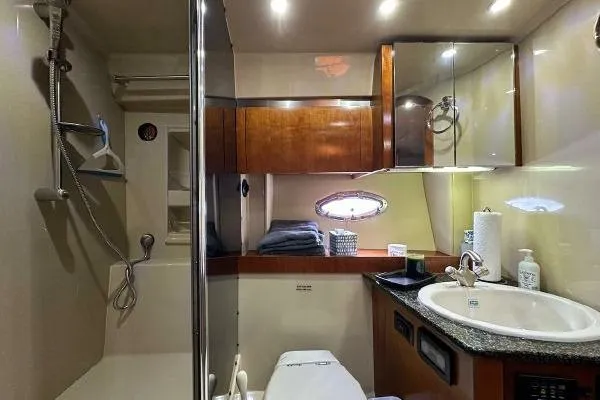 Slide: The Image of Luxurious 2005 Cruisers 420 yacht bathroom with modern amenities and elegant wood finishes. - 21