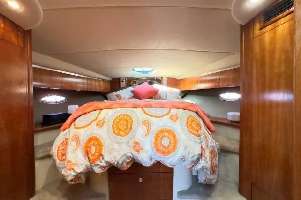 Slide: The Image of Luxurious 2005 Cruisers 420 yacht cabin with cozy bed and elegant wood finish. - 23