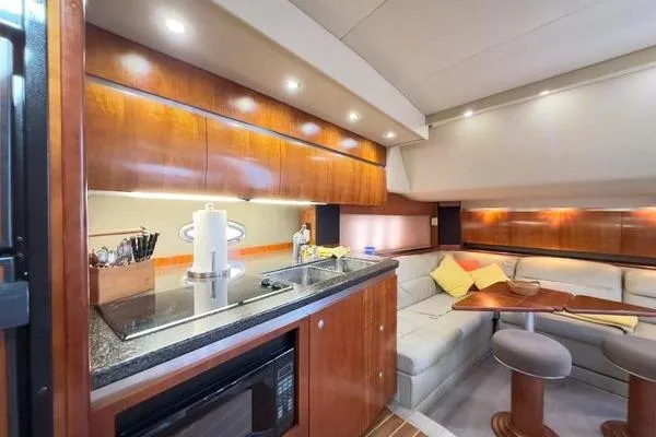 Slide: The Image of Luxurious 2005 Cruisers 420 yacht interior with modern kitchen and cozy seating area. - 28
